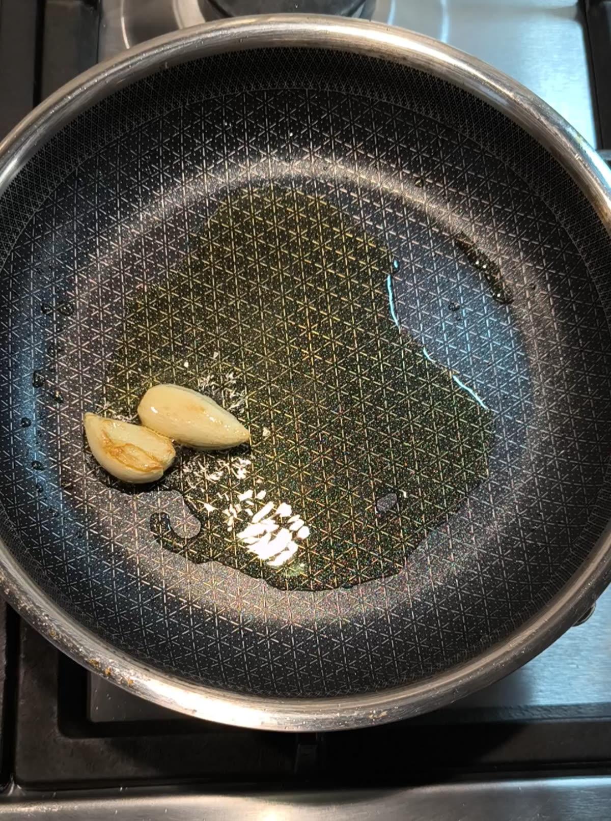 olio evo in padella con 2 spicchi di aglio