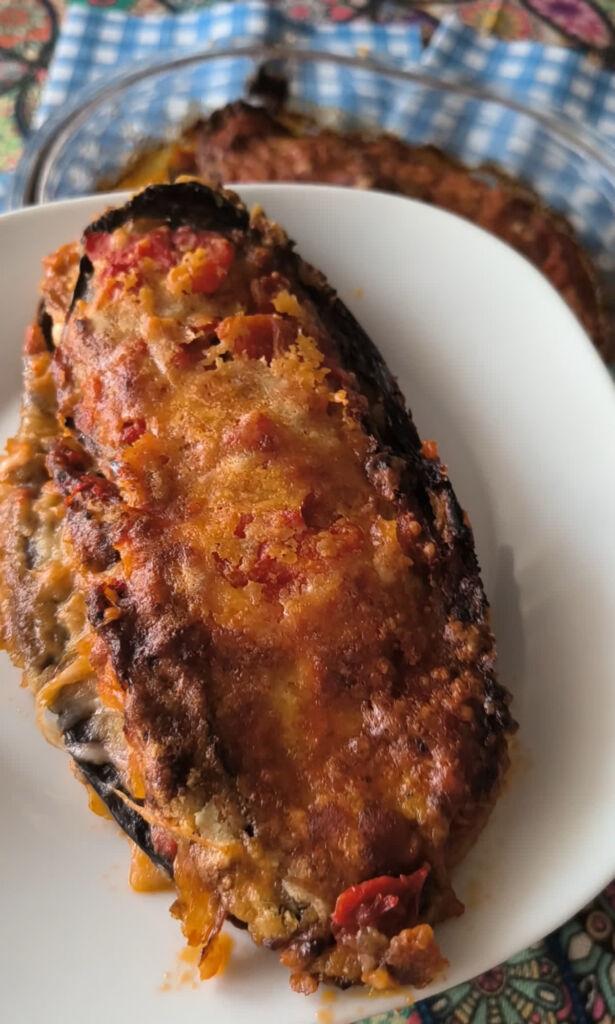 slice of aubergine parmigiana served on a plate with soft, stringy layers